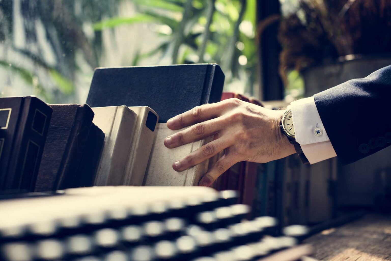 closeup-of-hand-getting-a-book-2022-12-15-23-41-52-utc-1536x1025